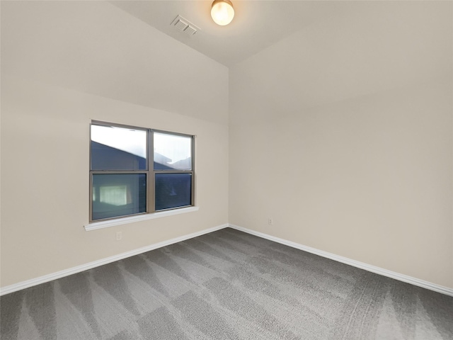 unfurnished room featuring vaulted ceiling and carpet flooring