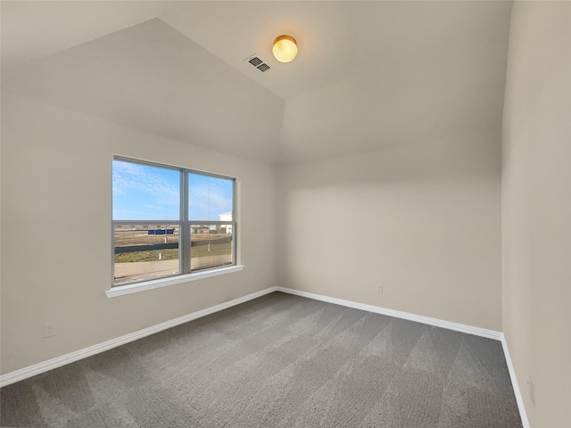 carpeted spare room with lofted ceiling