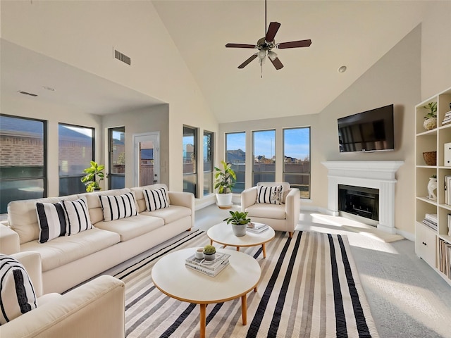 living room with ceiling fan, light colored carpet, and high vaulted ceiling