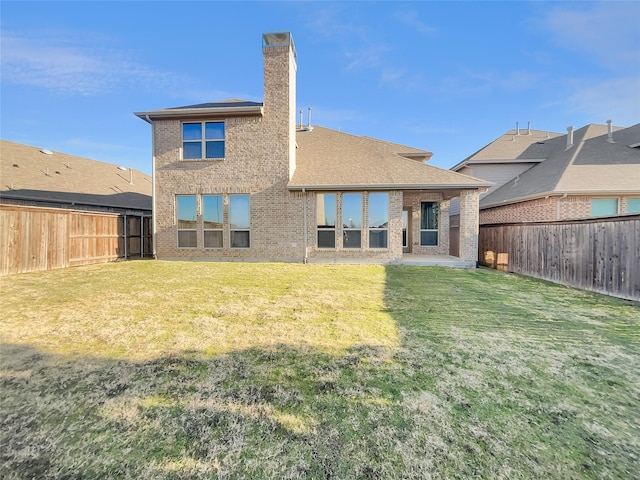 rear view of house with a lawn