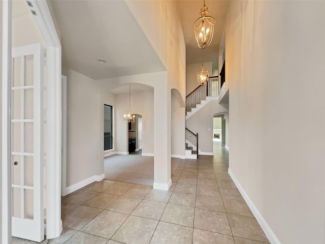 entrance foyer with an inviting chandelier and light tile patterned floors