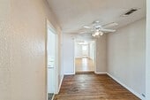 spare room featuring ceiling fan and dark hardwood / wood-style floors