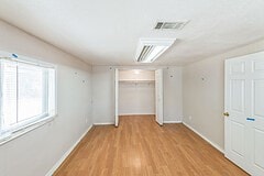 unfurnished bedroom featuring a closet and light hardwood / wood-style flooring