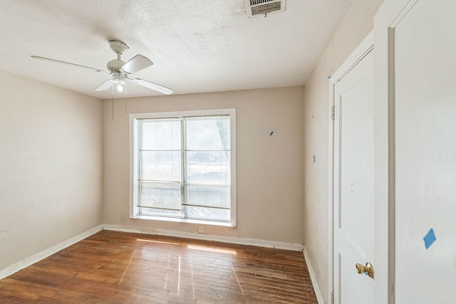 unfurnished bedroom featuring a textured ceiling, ceiling fan, and dark hardwood / wood-style floors