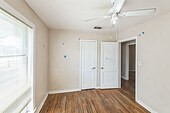 unfurnished room featuring ceiling fan and hardwood / wood-style flooring