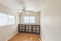 spare room featuring light wood-type flooring, ceiling fan, and plenty of natural light