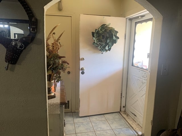 doorway with light tile flooring and a wealth of natural light