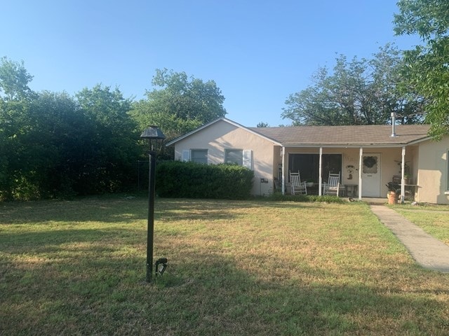 view of yard featuring covered porch