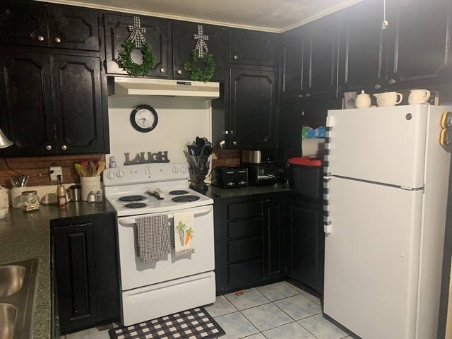 kitchen featuring white appliances, crown molding, and light tile floors