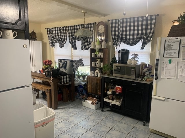 interior space featuring white fridge and light tile floors