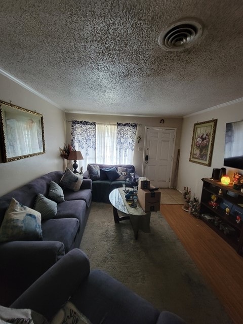 living room with a textured ceiling, ornamental molding, and wood-type flooring