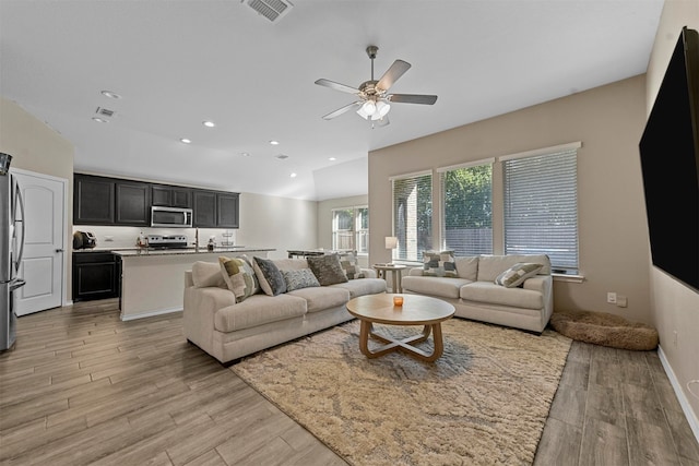 living room featuring ceiling fan and light hardwood / wood-style flooring