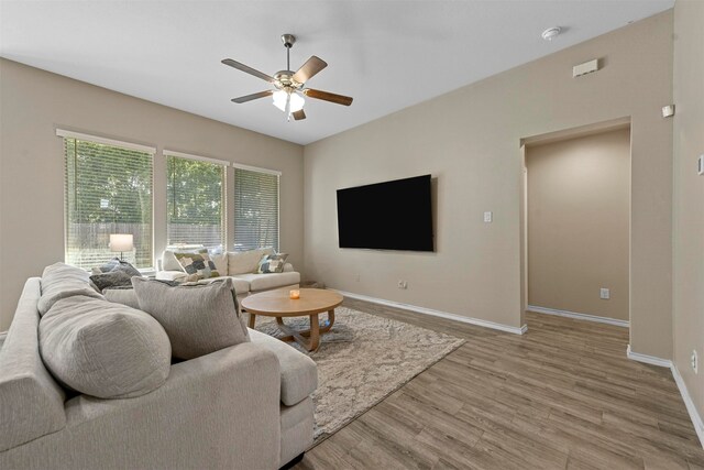 living room with hardwood / wood-style flooring and ceiling fan