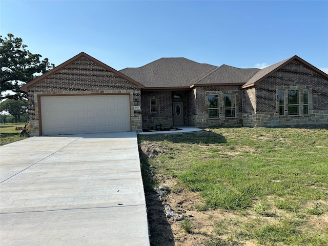 ranch-style house featuring driveway, an attached garage, and brick siding