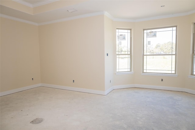 empty room with baseboards, concrete floors, and crown molding