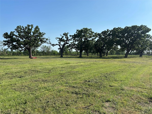view of yard with a rural view and fence