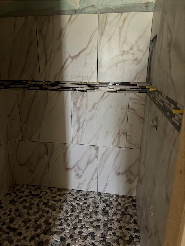 bathroom with a tile shower