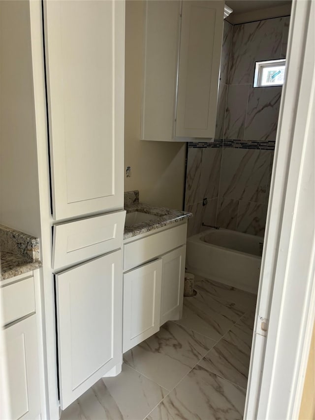full bathroom with shower / tub combination, vanity, and marble finish floor