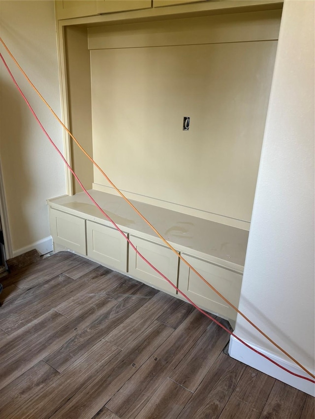 interior space featuring wood finished floors and baseboards