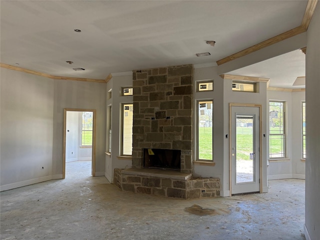 unfurnished living room with baseboards, ornamental molding, and a stone fireplace