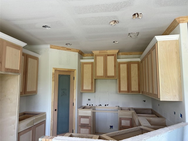 kitchen featuring light brown cabinets and ornamental molding