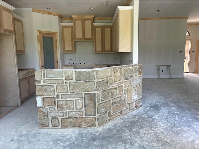 kitchen with ornamental molding, light brown cabinetry, and a kitchen island