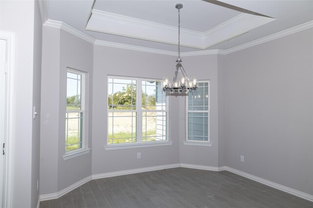 unfurnished dining area with a tray ceiling, dark wood finished floors, and baseboards