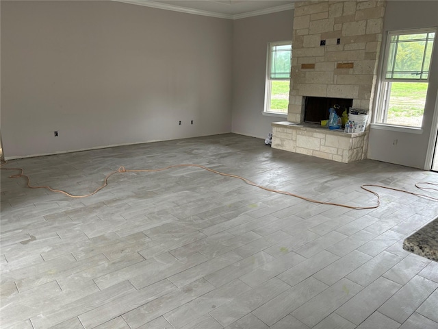 unfurnished living room featuring crown molding and a fireplace