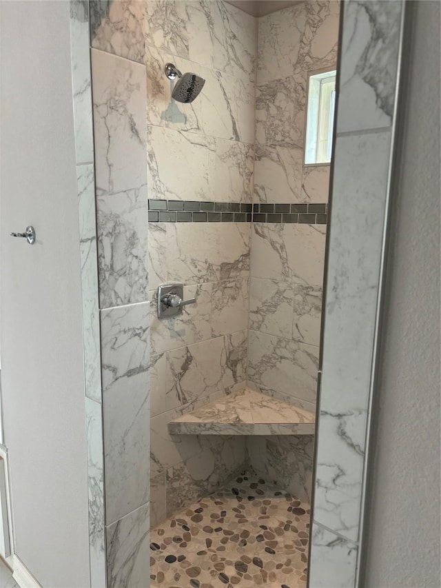 bathroom with a tile shower