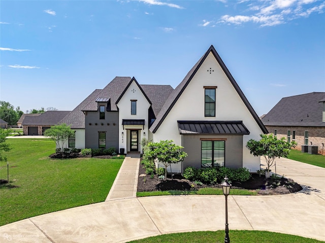 642 Caledonia Dr, Bossier City, LA 71111 - view of front of home featuring a standing seam roof, central AC unit, driveway, roof with shingles, and a front lawn
