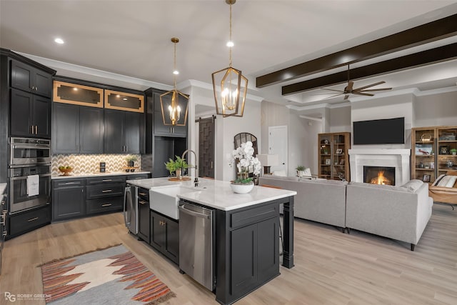 642 Caledonia Dr, Bossier City, LA 71111 - kitchen featuring tasteful backsplash, stainless steel appliances, beamed ceiling, a sink, and a ceiling fan