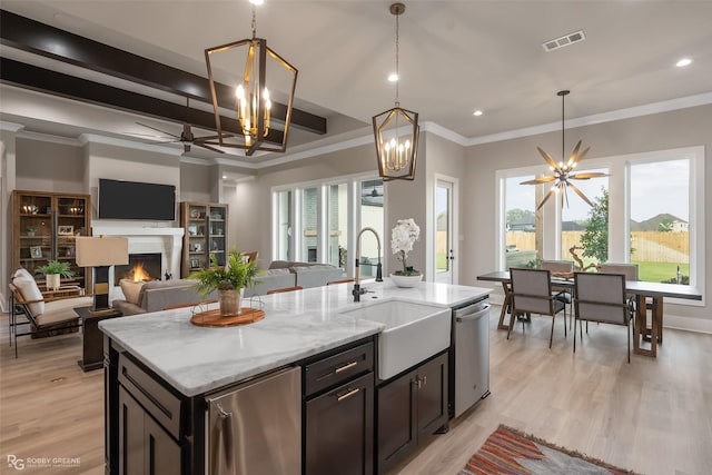 642 Caledonia Dr, Bossier City, LA 71111 - kitchen featuring stainless steel dishwasher, a sink, fridge, visible vents, and a warm lit fireplace