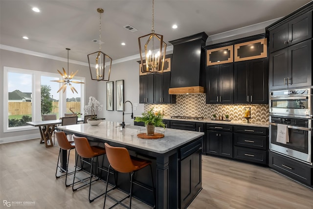 642 Caledonia Dr, Bossier City, LA 71111 - kitchen with an inviting chandelier, decorative backsplash, dark cabinetry, visible vents, and ornamental molding