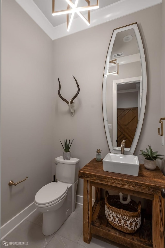 642 Caledonia Dr, Bossier City, LA 71111 - bathroom with toilet, tile patterned flooring, a sink, and baseboards