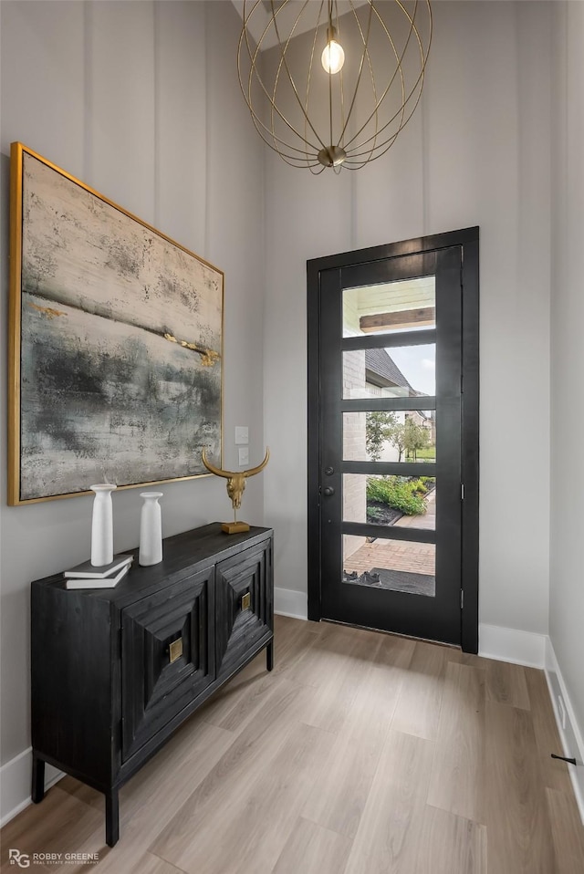 642 Caledonia Dr, Bossier City, LA 71111 - entryway with baseboards, wood finished floors, and a notable chandelier