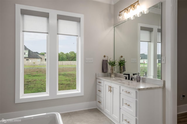 642 Caledonia Dr, Bossier City, LA 71111 - bathroom featuring baseboards, vanity, and plenty of natural light
