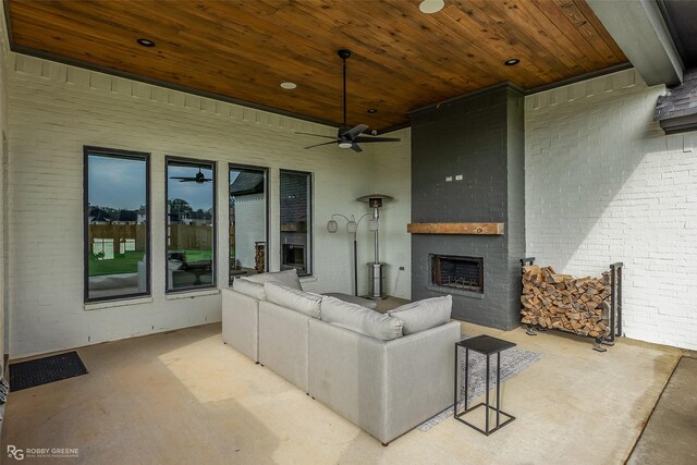 642 Caledonia Dr, Bossier City, LA 71111 - living area with an outdoor brick fireplace, wooden ceiling, a ceiling fan, and brick wall