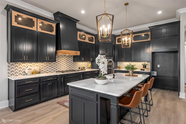 642 Caledonia Dr, Bossier City, LA 71111 - kitchen featuring light wood-type flooring, dark cabinets, and appliances with stainless steel finishes
