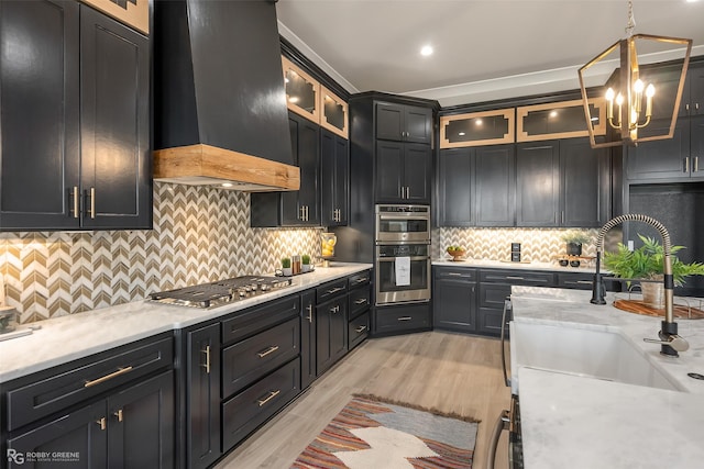 642 Caledonia Dr, Bossier City, LA 71111 - kitchen featuring a sink, appliances with stainless steel finishes, a chandelier, custom exhaust hood, and hanging light fixtures