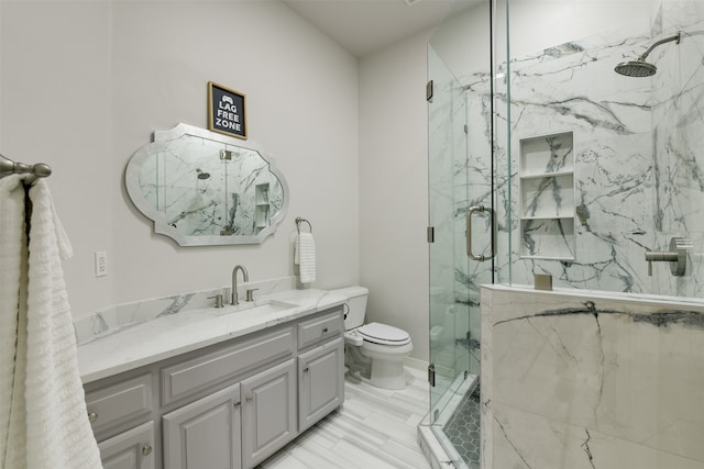 bathroom with tile patterned floors, an enclosed shower, vanity, and toilet