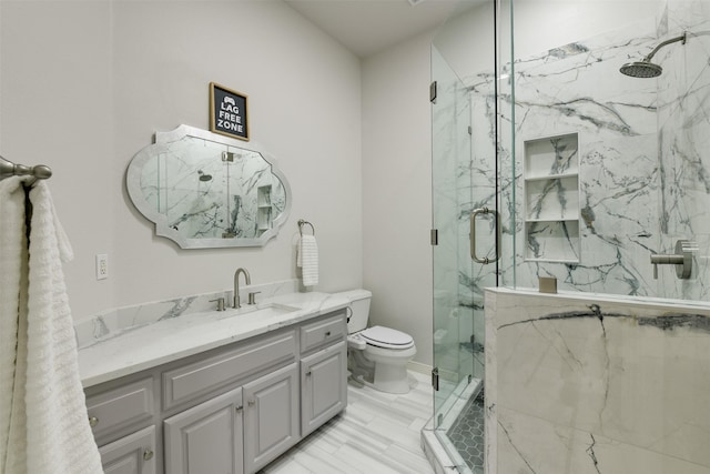 bathroom featuring toilet, vanity, and a marble finish shower