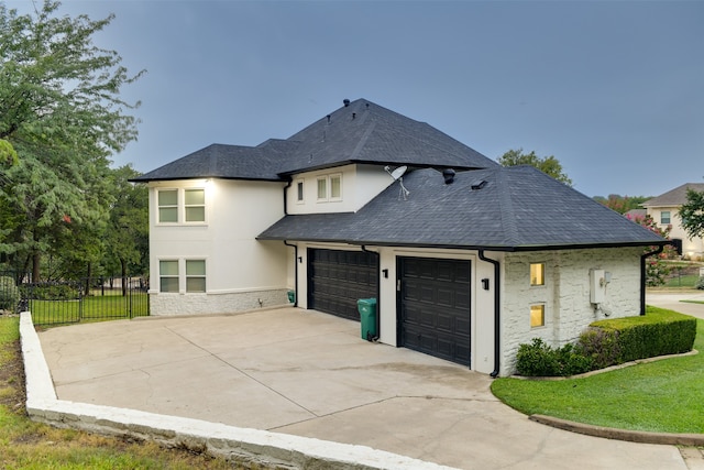 view of front of house featuring a garage and a front yard