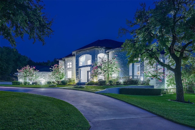 view of front of house with driveway and a lawn