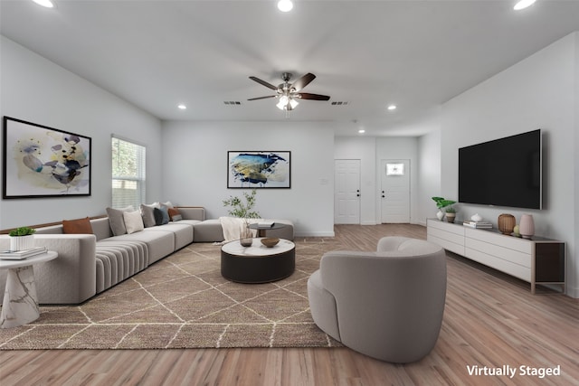 living room with hardwood / wood-style floors and ceiling fan