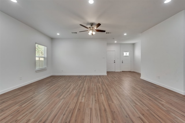 spare room featuring ceiling fan and light hardwood / wood-style flooring