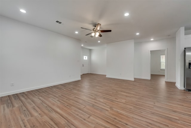 empty room featuring ceiling fan and light hardwood / wood-style floors