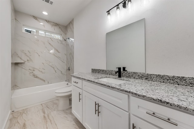 full bathroom featuring toilet, vanity, and tiled shower / bath combo