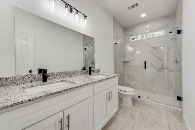 bathroom featuring vanity, toilet, and a shower with shower door