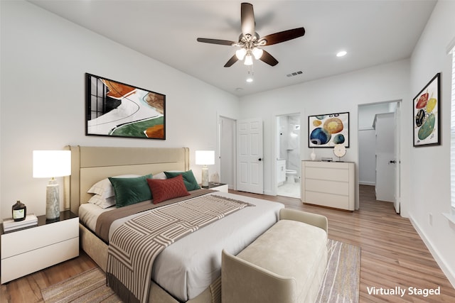 bedroom with connected bathroom, light hardwood / wood-style flooring, and ceiling fan