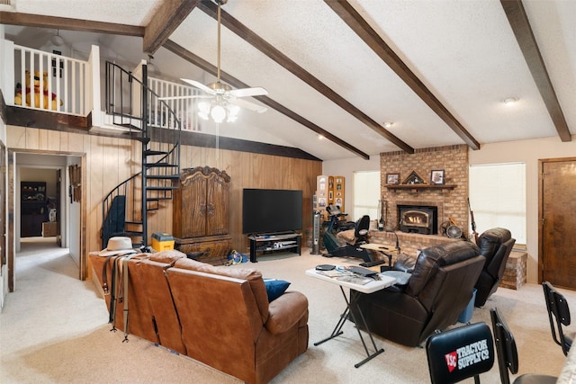 carpeted living room featuring brick wall, a brick fireplace, ceiling fan, wood walls, and beam ceiling